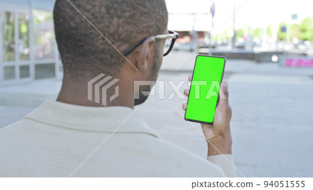 African Man Using Smartphone with Green Screen Outdoor African Man Using Smartphone with Green Screen Outdoor 94051555