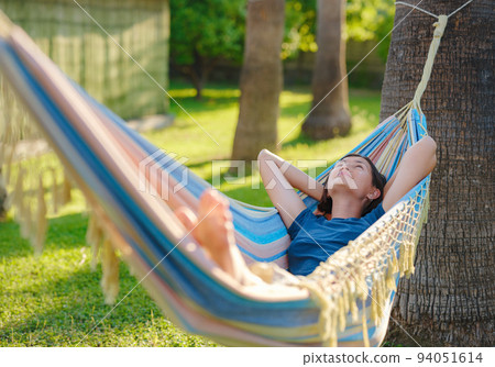 young beautiful lady posing while lying on hammock, 94051614