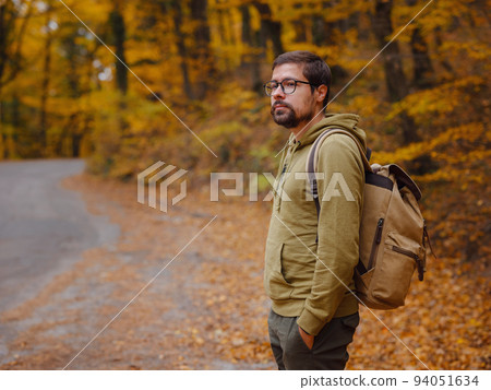 Young handsome man posing in autumn forest. 94051634