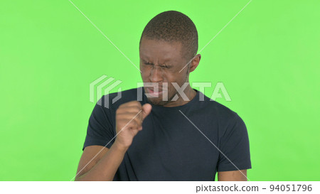 Coughing Young African Man Feeling unwell on Green Background Coughing Young African Man Feeling unwell on Green Background 94051796