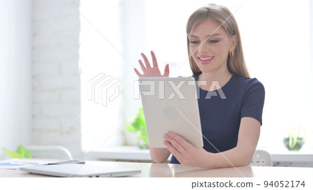 Woman making Video Call on Tablet in Office 94052174