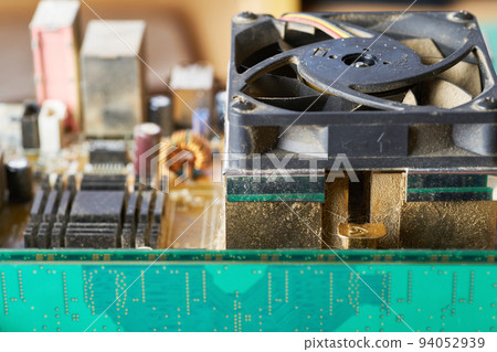 Old motherboard covered in dust and dirt. Close-up. Old motherboard covered in dust and dirt. Close-up. 94052939