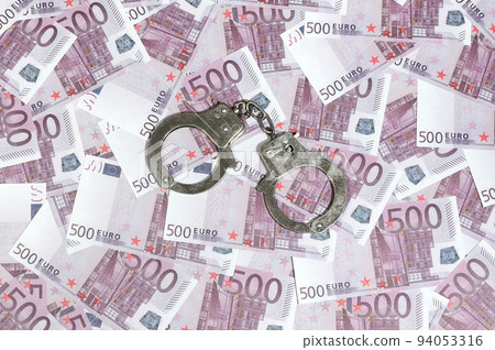 Handcuffs on five hundred euros background. Financial crime, dirty money and corruption concept - 500 money bills and dirty steel handcuffs 94053316