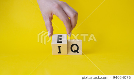 IQ or EQ symbol. Businessman hand turns cube with words IQ, intelligence quotient to EQ, emotional quotient. Beautiful yellow background. Emotional and intelligence quotient concept. Copy space. IQ or EQ symbol. Businessman hand turns cube with words IQ, intelligence quotient to EQ, emotional quotient. Beautiful yellow background. Emotional and intelligence quotient concept. Copy space. 94054076