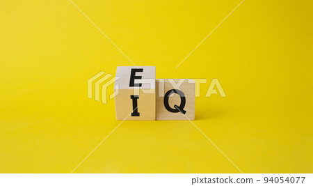 IQ or EQ symbol. Turned cube with words IQ, intelligence quotient to EQ, emotional quotient. Beautiful yellow background. Emotional and intelligence quotient concept. Copy space. IQ or EQ symbol. Turned cube with words IQ, intelligence quotient to EQ, emotional quotient. Beautiful yellow background. Emotional and intelligence quotient concept. Copy space. 94054077