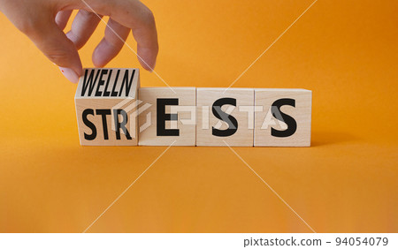 Wellness and Stress symbol. Businessman hand. Turned Wooden cubes with word Wellness and Stress. Beautiful orange background. Business and Wellness and Stress concept. Copy space. Wellness and Stress symbol. Businessman hand. Turned Wooden cubes with word Wellness and Stress. Beautiful orange background. Business and Wellness and Stress concept. Copy space. 94054079