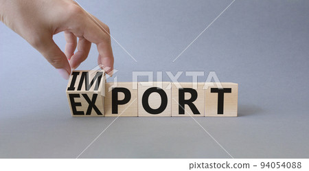 Import and Export symbol. Businessman hand turnes wooden cubes and changes word Export to Import. Beautiful grey background. Business concept. Copy space. Import and Export symbol. Businessman hand turnes wooden cubes and changes word Export to Import. Beautiful grey background. Business concept. Copy space. 94054088