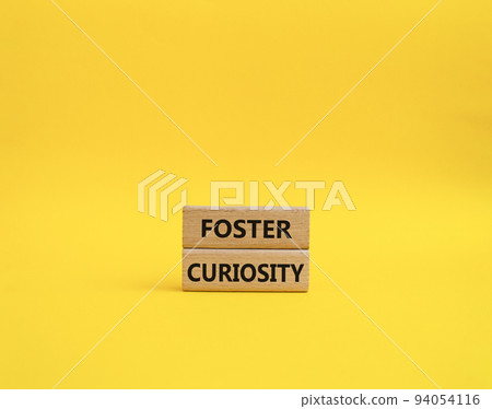 Foster curiosity symbol. Concept word Foster curiosity on wooden blocks. Beautiful yellow background. Business and Foster curiosity concept. Copy space Foster curiosity symbol. Concept word Foster curiosity on wooden blocks. Beautiful yellow background. Business and Foster curiosity concept. Copy space 94054116