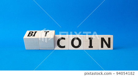 Bitcoin symbol. Turned wooden cubes with words Bitcoin and Coin. Beautiful blue background. Business and Bitcoin concept. Copy space Bitcoin symbol. Turned wooden cubes with words Bitcoin and Coin. Beautiful blue background. Business and Bitcoin concept. Copy space 94054182