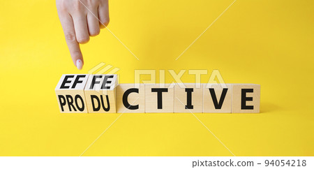 Effective and Productive symbol. Businessman Hand turns a cube and changes the word Productive to Effective. Beautiful yellow background. Business and Effective and Productive concept. Copy space Effective and Productive symbol. Businessman Hand turns a cube and changes the word Productive to Effective. Beautiful yellow background. Business and Effective and Productive concept. Copy space 94054218
