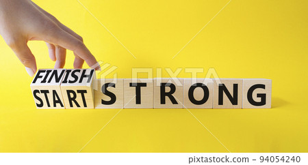 Start and Finish Strong. Businessman hand Turnes wooden cubes and changes words Start Strong to Finish Strong. Beautiful yellow background. Business concept. Copy space Start and Finish Strong. Businessman hand Turnes wooden cubes and changes words Start Strong to Finish Strong. Beautiful yellow background. Business concept. Copy space 94054240