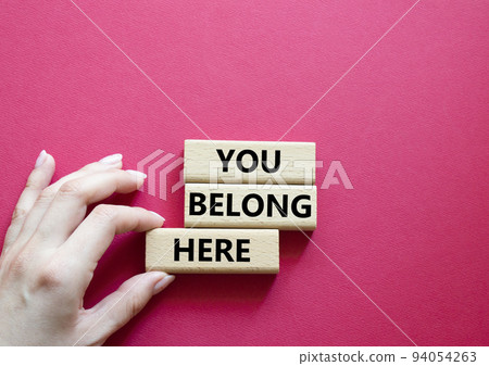 You belong here symbol. Wooden blocks with words You belong here. Beautiful red background. Businessman hand. Business and You belong here concept. Copy space. You belong here symbol. Wooden blocks with words You belong here. Beautiful red background. Businessman hand. Business and You belong here concept. Copy space. 94054263