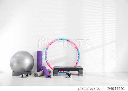 Different sports equipment near white wall in gym Different sports equipment near white wall in gym 94055291