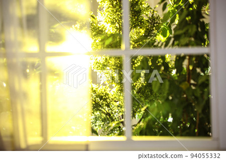 Beautiful view through window on garden in morning Beautiful view through window on garden in morning 94055332