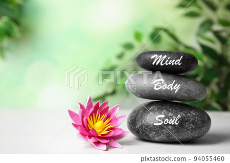 Stones with words Mind, Body, Soul and lotus flower on white wooden table. Zen lifestyle Stones with words Mind, Body, Soul and lotus flower on white wooden table. Zen lifestyle 94055460