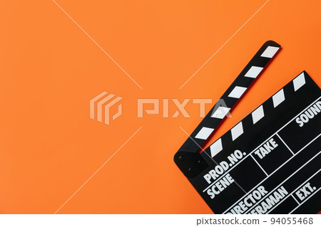 Clapper board on orange background, top view with space for text. Cinema production Clapper board on orange background, top view with space for text. Cinema production 94055468