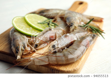 Fresh raw shrimps on white wooden table, closeup Fresh raw shrimps on white wooden table, closeup 94055513