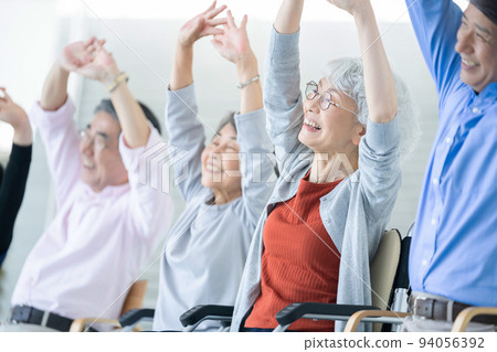 Elderly housing with care users doing gymnastics Senior image Caregiver 94056392