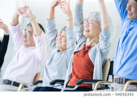 Elderly housing with care users doing gymnastics Senior image Caregiver 94056393