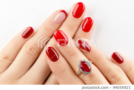 Womans hands with trendy red shiny manicure. Beauty treatment spa body care concept 94056921