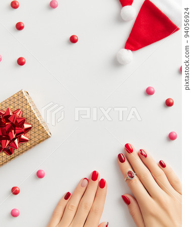 Female hand with manicure on white background. Christmas Valentines day trendy shiny nail design Female hand with manicure on white background. Christmas Valentines day trendy shiny nail design 94056924