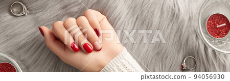 Female hand with nail design Christmas valentines day on gray background. Manicure, pedicure beauty salon concept. 94056930