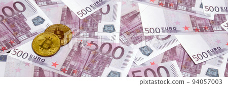 Bitcoins over pile of five hundred euro banknotes. Traditional money versus cryptocurrency concept. Gold coin above 500 euro bills. Close up 94057003