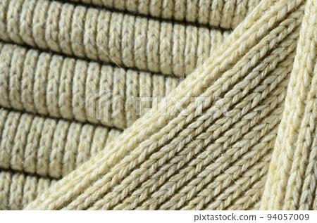 Composition of a soft yellow knitted sweater. Macro texture of bindings in yarns Composition of a soft yellow knitted sweater. Macro texture of bindings in yarns 94057009