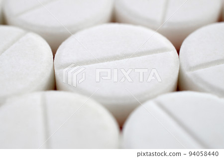 Close-up image of white pills. Macro with extremely shallow depth of field Close-up image of white pills. Macro with extremely shallow depth of field 94058440