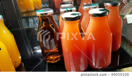 orange juice, mix fruit juice and apple juice inside the display fridge 94059108