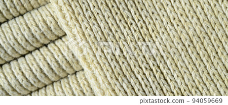 Composition of a soft yellow knitted sweater. Macro texture of bindings in yarns Composition of a soft yellow knitted sweater. Macro texture of bindings in yarns 94059669