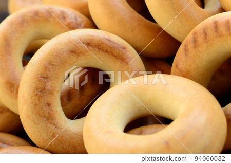 Close-up photo of fresh yellow bagels. A popular kind of flour products. One of the traditional Russian treats for tea Close-up photo of fresh yellow bagels. A popular kind of flour products. One of the traditional Russian treats for tea 94060082