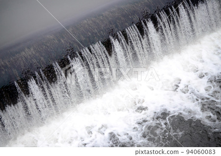 A picture of the flowing water. The dam is designed to regulate the water level in rivers within the city and to provide technical water to industrial objects A picture of the flowing water. The dam is designed to regulate the water level in rivers within the city and to provide technical water to industrial objects 94060083