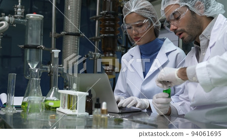 Two scientist in professional uniform working in laboratory 94061695