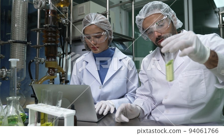 Two scientist in professional uniform working in laboratory 94061766