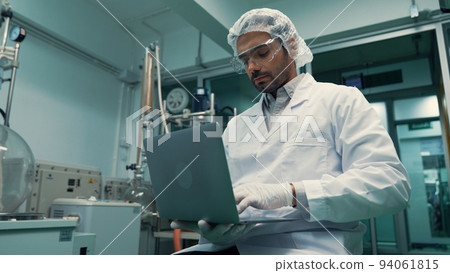 Portrait of a man scientist in uniform working in curative laboratory 94061815