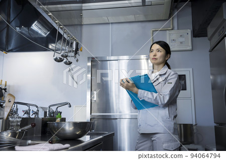 Woman wearing work clothes, kitchen maintenance image 94064794