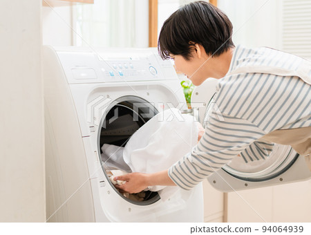 Young woman doing laundry Parts 94064939