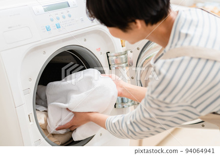 Young woman doing laundry Parts 94064941