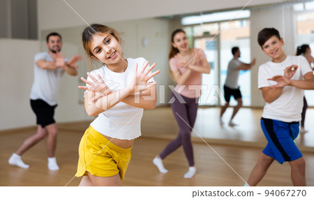 Young girl exercising aerobic dance with family 94067270