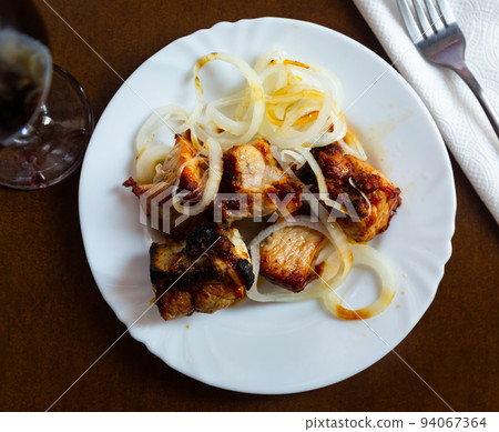 Traditional Georgian grilled pork shashlyk with onions 94067364