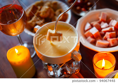 Cheese fondue with bread and snacks 94067448