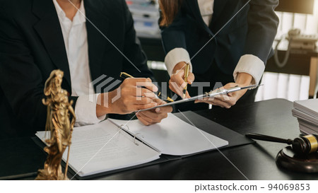 business people and lawyers discussing contract papers sitting at the table. Concepts of law, advice, legal services. in morning light.. 94069853