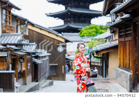 A woman in a kimono walking on the streets of Kyoto 94070432