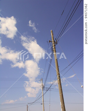 Telephone poles and blue sky on a farm road in early spring Telephone poles and blue sky on a farm road in early spring 94071362