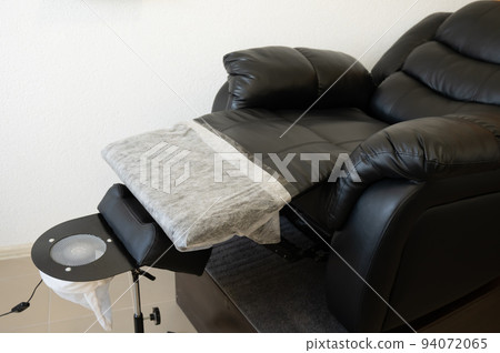 Black pedicure chair with dust vacuum cleaner in beauty salon.  94072065