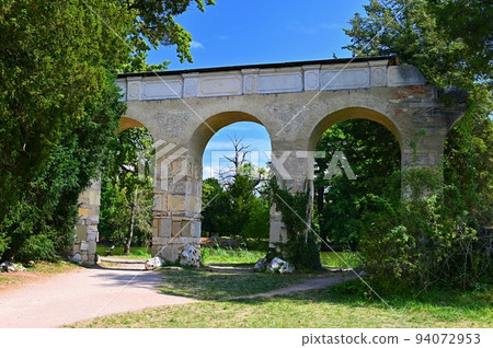 Old aqueduct - Lednice - South Moravia - Czech Republic. A beautiful park with a lake in the castle grounds. Landscape with nature in summer time. Old aqueduct - Lednice - South Moravia - Czech Republic. A beautiful park with a lake in the castle grounds. Landscape with nature in summer time. 94072953