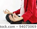 Pregnant woman sits in bed in her bedroom meditating alone in peace and happiness. The new mother resting by sitting down to chill out. 94073069