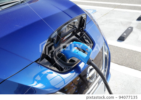 Electric car under charge Electric car under charge 94077135