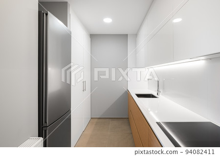 White empty modern kitchen with fridge, stove and sink White empty modern kitchen with fridge, stove and sink 94082411